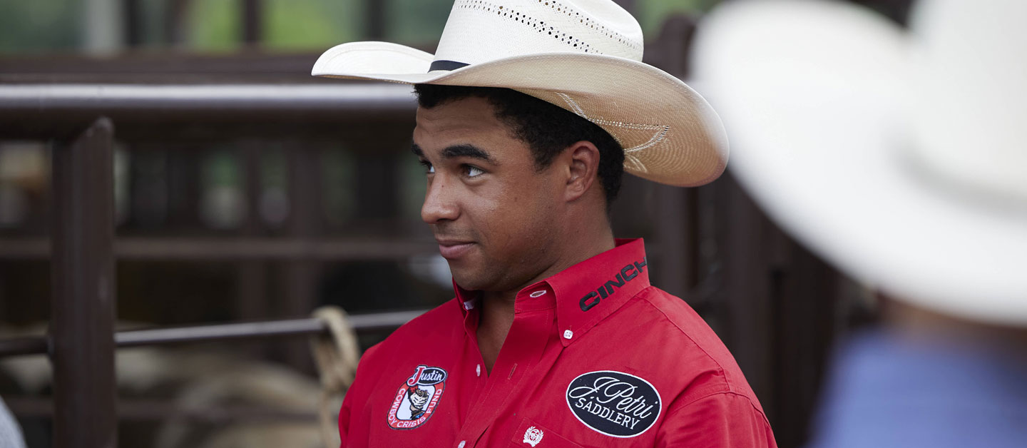 Laramie Mosley wearing a cowboy hat looking away from the camera.